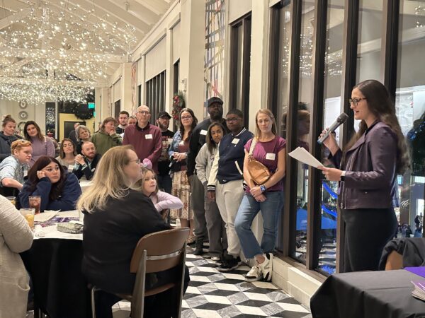 Danielle Lance speaking to a group of families from Epilepsy Alliance America at a restaurant during Epilepsy Awareness Day at Disneyland in California.